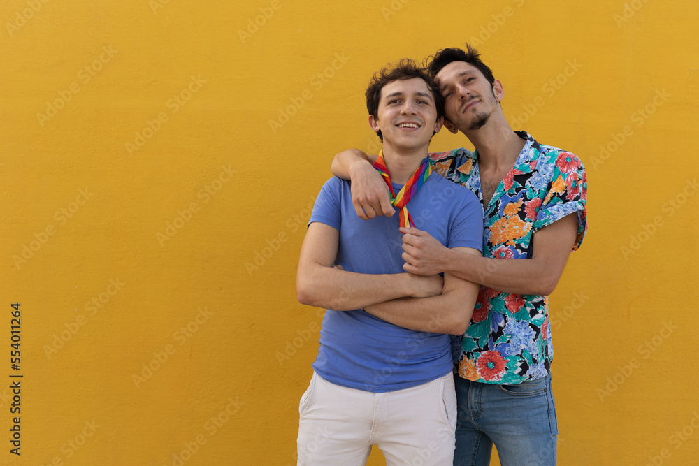 Naklejka premium Happy young couple embraces. Two men enjoy outside..