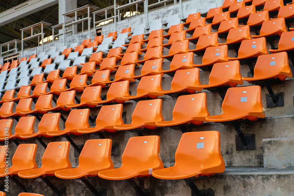 Orange white stadium chairs in outdoor field