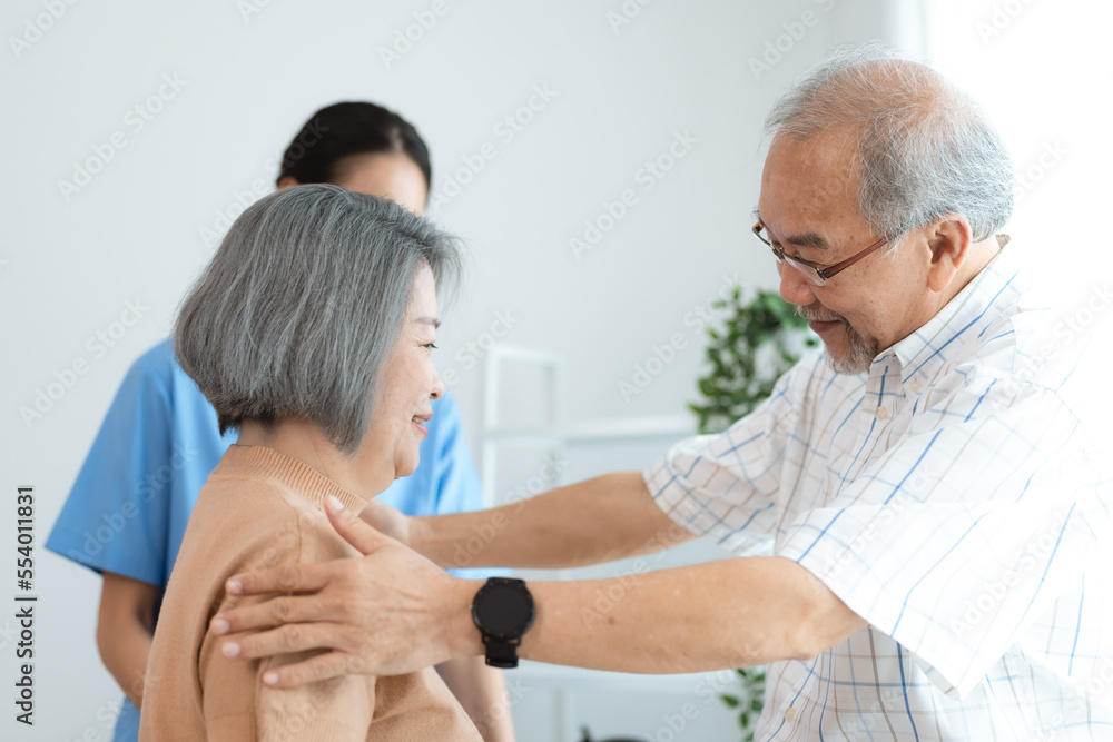 Portrait of happy senior couple with wife embracing husband, nurse doctor senior care caregiver help assistance retirement at home nursing, or hugging after sick in hospital Portrait of happy senior couple with wife embracing husband, nurse doctor senior care caregiver help assistance retirement at home nursing, or hugging after sick in hospital