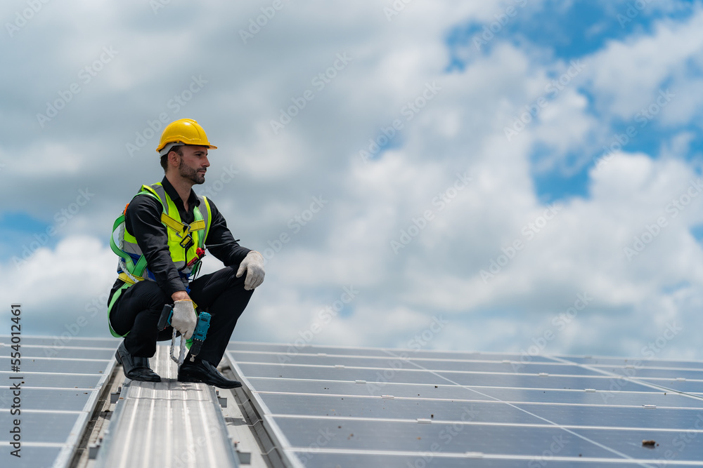 technician engineer working on checking maintenance service with solar batteries near solar panels at sunny day in solar power plant station on rooftop, electricity energy of photovoltaic industrial technician engineer working on checking maintenance service with solar batteries near solar panels at sunny day in solar power plant station on rooftop, electricity energy of photovoltaic industrial