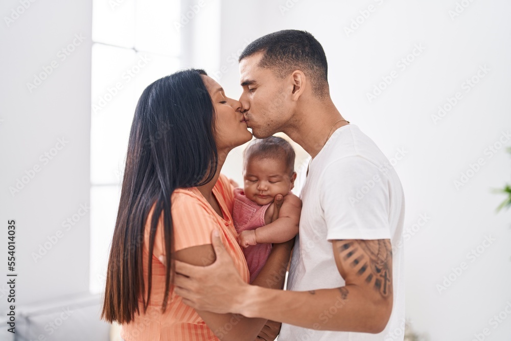 Hispanic family hugging each other kissing at home Hispanic family hugging each other kissing at home