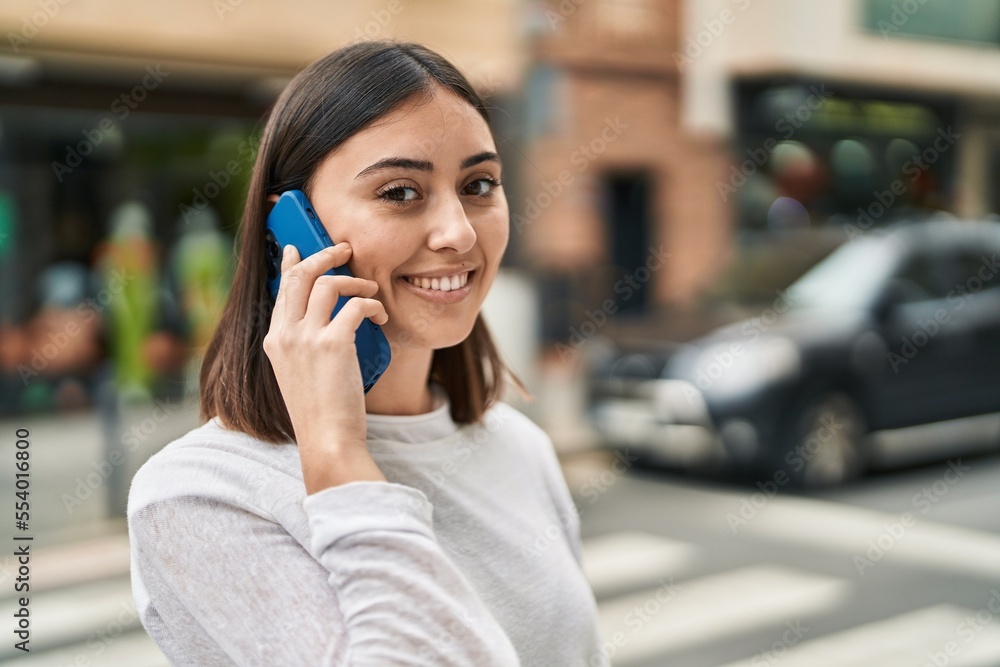 Young hispanic woman smiling confident talking on the smartphone at street Young hispanic woman smiling confident talking on the smartphone at street