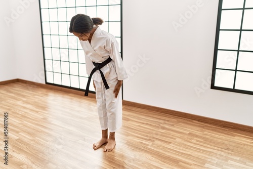 Fototapet African american girl wearing kimono training karate at sport center