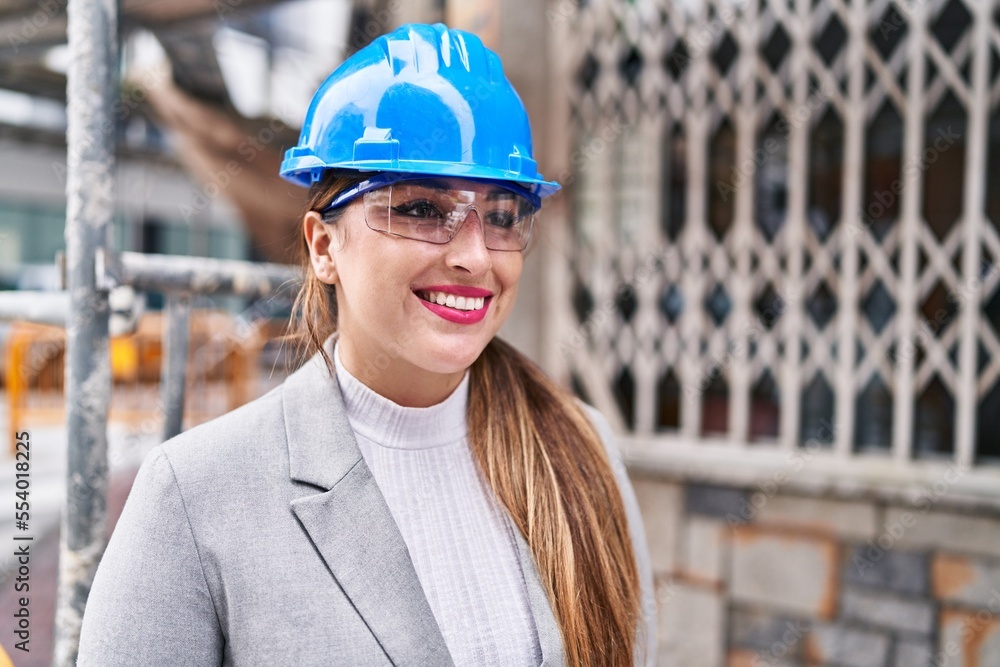 Young beautiful hispanic woman architect smiling confident standing at street