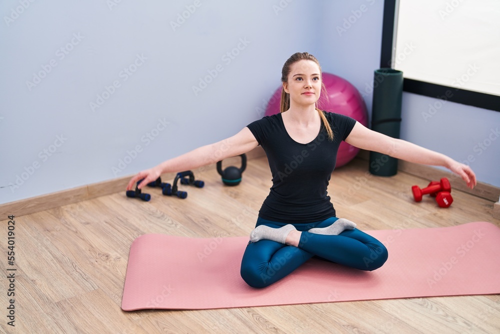 Young blonde woman smiling confident training yoga at sport center