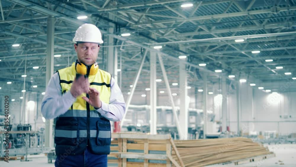 Industrial engineer starts talking on the phone Industrial engineer starts talking on the phone