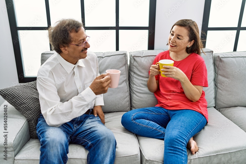 Middle age man and woman couple smiling confident drinking coffee at home Middle age man and woman couple smiling confident drinking coffee at home