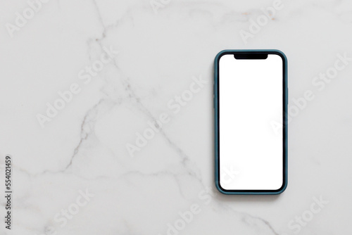 Obraz na płótnie Smartphone with blank white screen in case on marble table, Mobile phone mock up w salonie