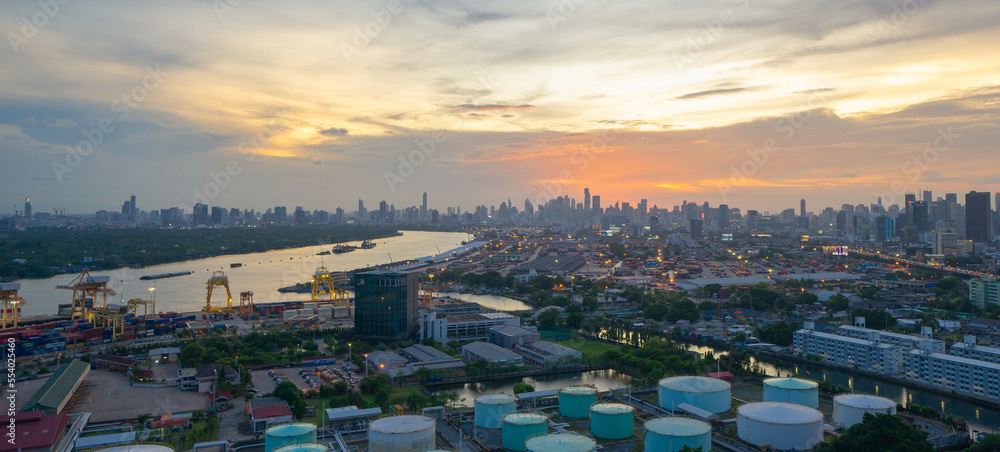 Aerial view of container cargo ship in the export and import business and logistics international goods in urban city. Shipping to the harbour by crane in Bangkok harbour, Thailand.
