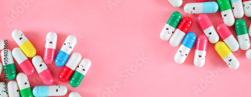 Colorful medical pills with funny faces background