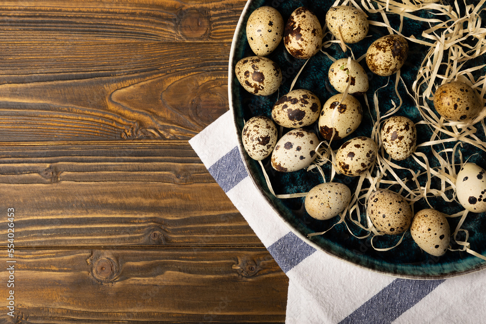 Quail eggs in a plate on a dark brown wooden background. Healthy food. Diet. top view. free space. Quail eggs in a plate on a dark brown wooden background. Healthy food. Diet. top view. free space.