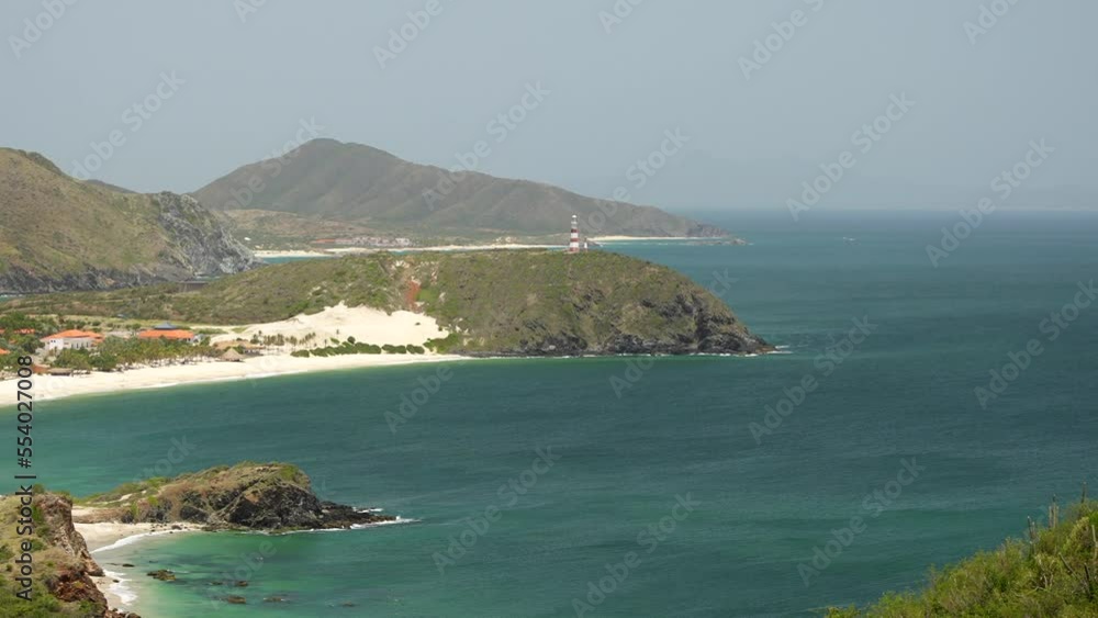 Top zoom view of the Puerto Viejo beach and Punta Zaragoza lighthouse on a cliff. Margarita island, Venezuela. Top zoom view of the Puerto Viejo beach and Punta Zaragoza lighthouse on a cliff. Margarita island, Venezuela.