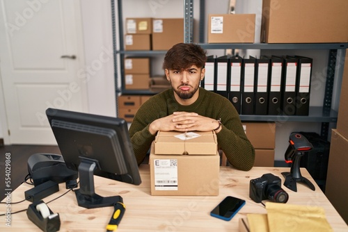 Arab man with beard working at small business ecommerce depressed and worry for distress, crying angry and afraid. sad expression.