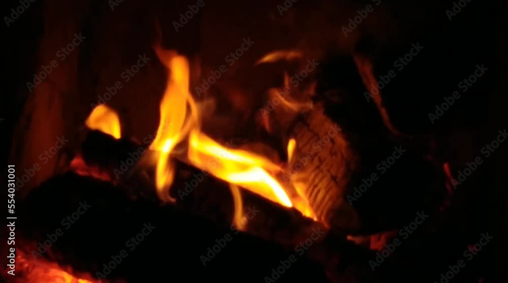 The fireplace is lit for warmth in the house The fireplace is lit for warmth in the house