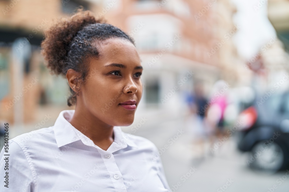 African american woman looking to the side with serious expression at street African american woman looking to the side with serious expression at street