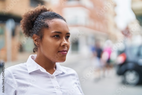 African american woman looking to the side with serious expression at street