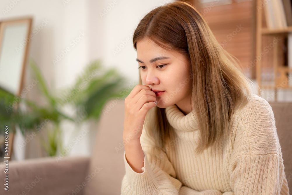 Young asian woman wearing sweater and touching mouth with hand while feeling sad and disappointed in holiday Young asian woman wearing sweater and touching mouth with hand while feeling sad and disappointed in holiday