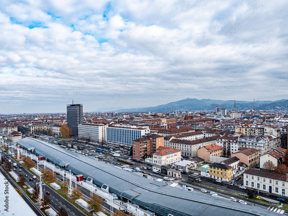 Obraz premium Skyline of Turin, Italy, in winter. The mountain in back and the Mole Antonelliana, Piazza Castello, Porta Susa Station, Turin court and the city centre. The city in winter with a blue sky