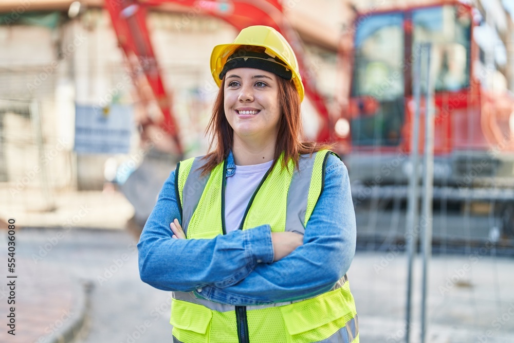 Young beautiful plus size woman architect smiling confident standing with arms crossed gesture at street Young beautiful plus size woman architect smiling confident standing with arms crossed gesture at street