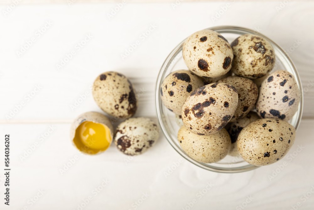 Quail eggs in a plate on a white wooden background. Healthy food. Diet. top view. free space. Quail eggs in a plate on a white wooden background. Healthy food. Diet. top view. free space.