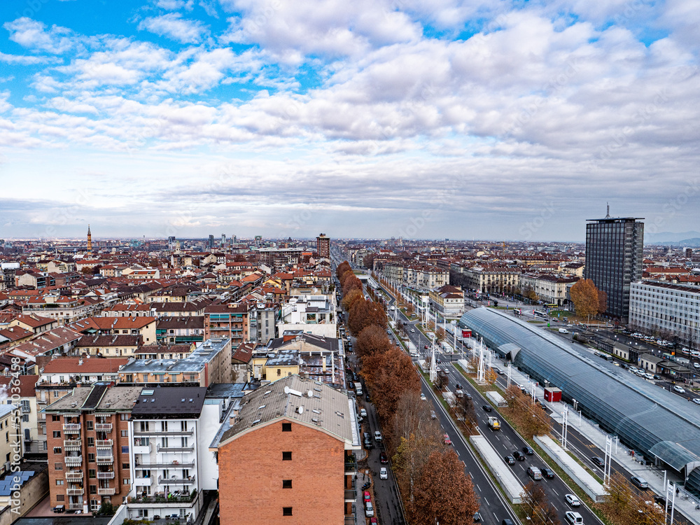 Skyline of Turin, Italy, in winter. The mountain in back and the Mole Antonelliana, Piazza Castello, Porta Susa Station, Turin court and the city centre. The city in winter with a blue sky
