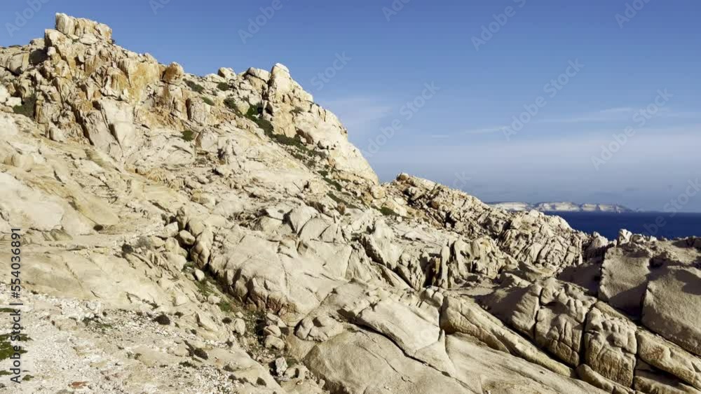 Big rocks and stones cliff near the blue water of ocean rocky shore coast with nobody in summer, heavenly holiday natural place to relax and to be peace of mind, near Bonifacio in Corsica (France) Big rocks and stones cliff near the blue water of ocean rocky shore coast with nobody in summer, heavenly holiday natural place to relax and to be peace of mind, near Bonifacio in Corsica (France)