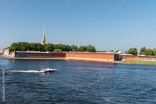 view from the Neva River to the Peter and Paul Fortress and a sandy beach with people resting in the center of the city of St. Petersburg, Russia