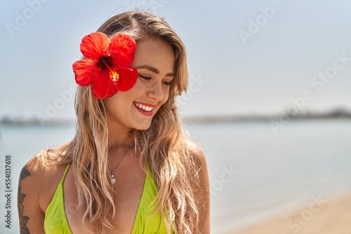 Young woman tourist wearing bikini smiling confident at seaside