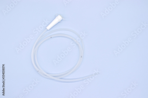 Nasogastric tube with white head on blue background,top view