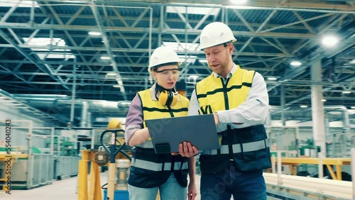 Fiberglass factory with two industrial engineers communicating