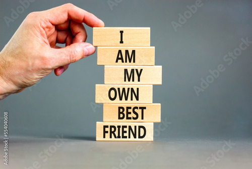 I am my own best friend symbol. Concept words I am my own best friend on wooden blocks on a beautiful grey table grey background. Businessman hand. Business i am my own best friend concept.