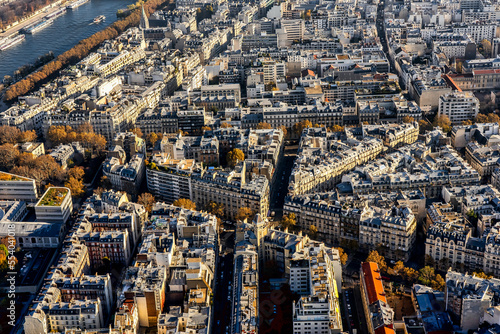 Beautiful panoramic view above historical Parisian buildings from the Eiffel Tower. Scenery of Paris and Seine River. Aerial view of roofs.