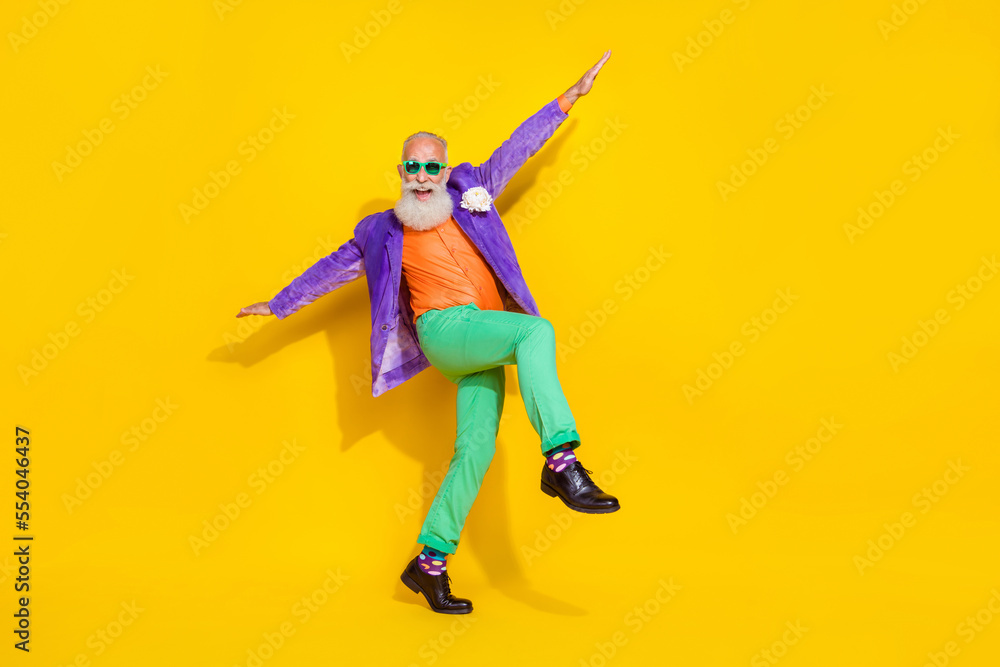 Full length photo of carefree positive pensioner wear trendy colorful outfit have fun go empty space isolated on yellow color background
