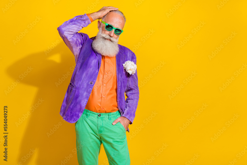 Photo portrait of handsome granddad cool hipster touch hair enjoy dating dressed stylish colorful look isolated on yellow color background Photo portrait of handsome granddad cool hipster touch hair enjoy dating dressed stylish colorful look isolated on yellow color background
