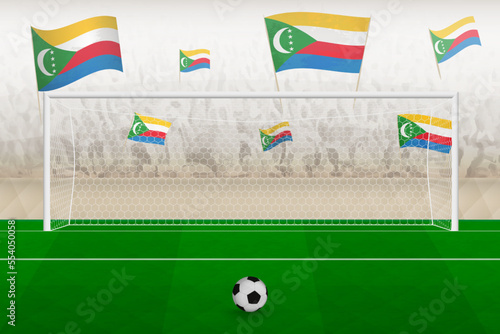 Comoros football team fans with flags of Comoros cheering on stadium, penalty kick concept in a soccer match.