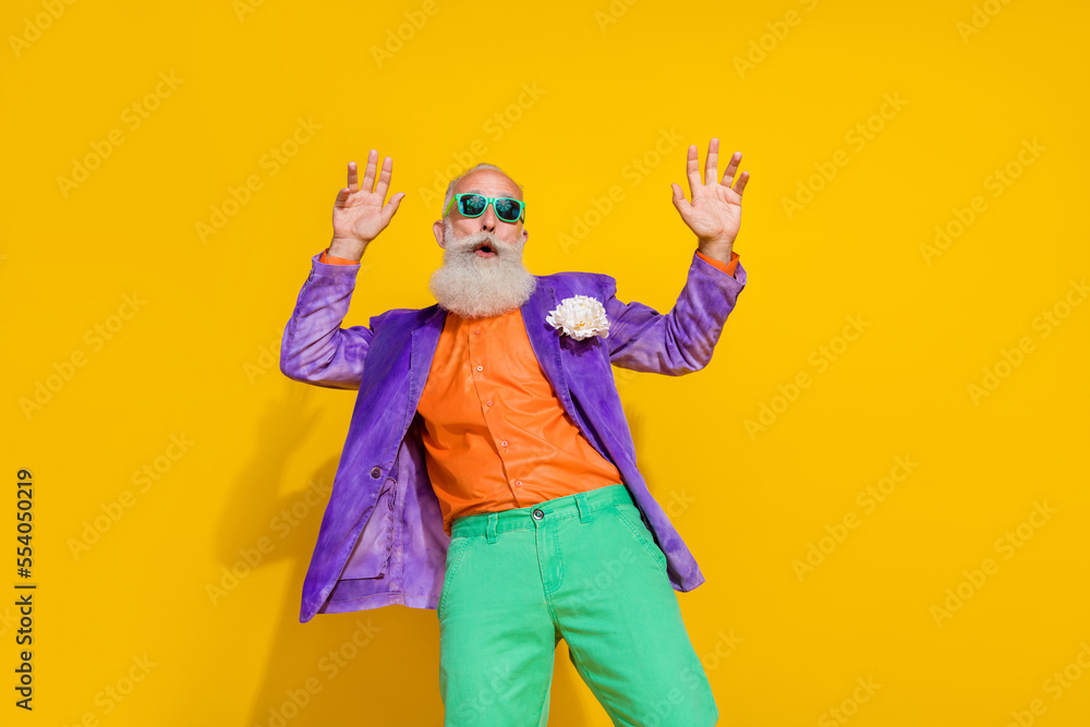 Photo of retired energetic active man dressed bright clothes enjoy event holiday weekend catch rhythm isolated on yellow color background Photo of retired energetic active man dressed bright clothes enjoy event holiday weekend catch rhythm isolated on yellow color background
