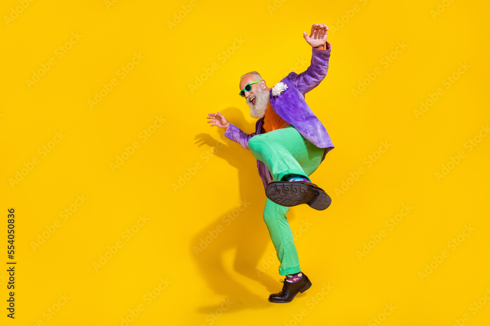 Full body photo of handsome grandpa have fun celebrate weekend have fun wear trendy colorful clothes isolated on yellow color background