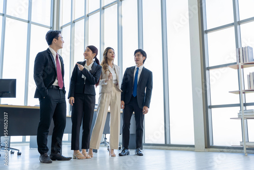 A group of young Asian businessmen Talking and planning work happily and have fun. at the company's office