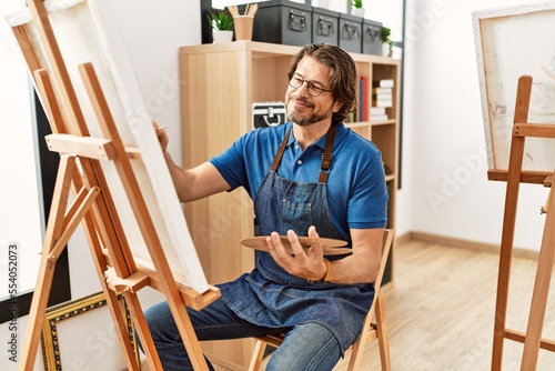 Middle age caucasian man smiling confident drawing at art studio