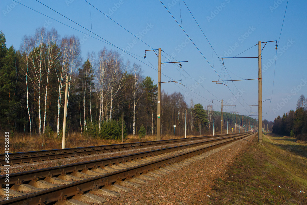 Railway tracks on a summer day and a view of the station Railway tracks on a summer day and a view of the station