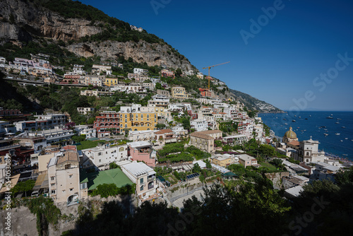 Positano with hotels and houses on hills leading down to coast, comfortable beaches and azure sea on Amalfi Coast in Campania, Italy. © AS Photo Family
