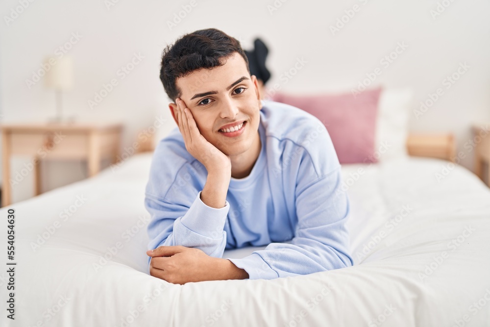 Young non binary man smiling confident lying on bed Young non binary man smiling confident lying on bed