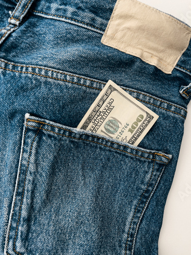 Close up detailed shot of dollars in blue jeans pocket. Money in the pocket of jeans. 100 one hundred bucks