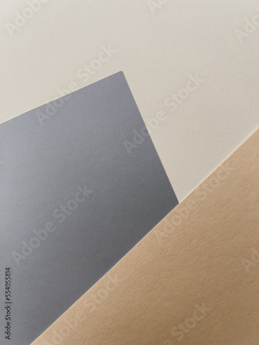Abstract colourful paper background on office table with texture. White, beige, blue