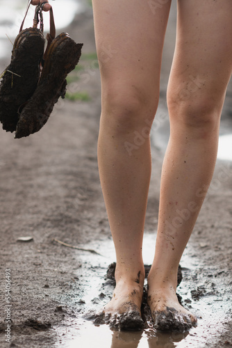 Young girls's muddy feet. Selective focus.