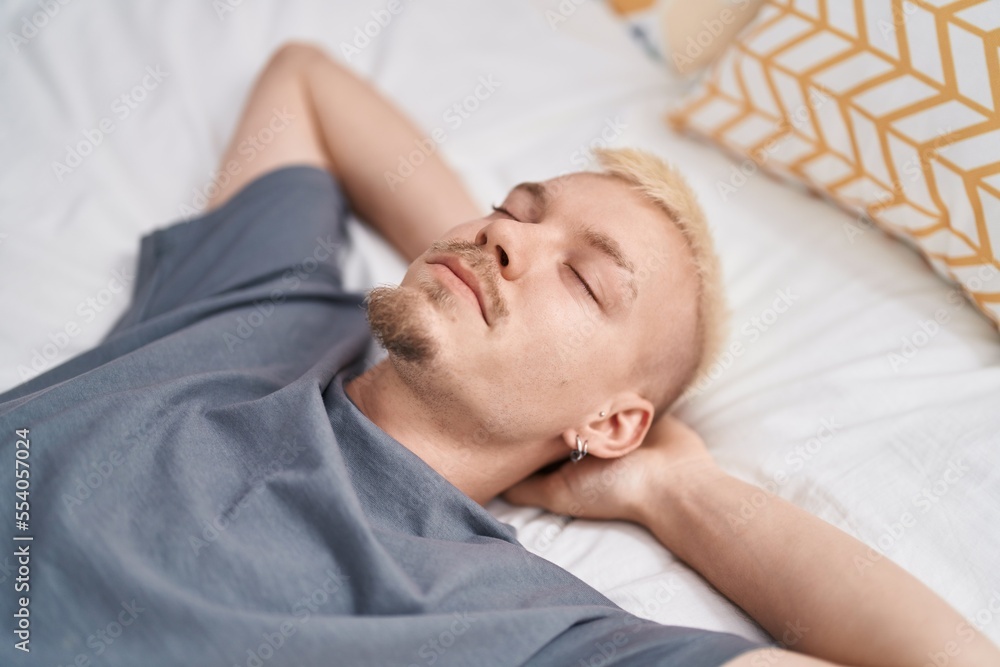 Young caucasian man lying on bed sleeping at bedroom Young caucasian man lying on bed sleeping at bedroom