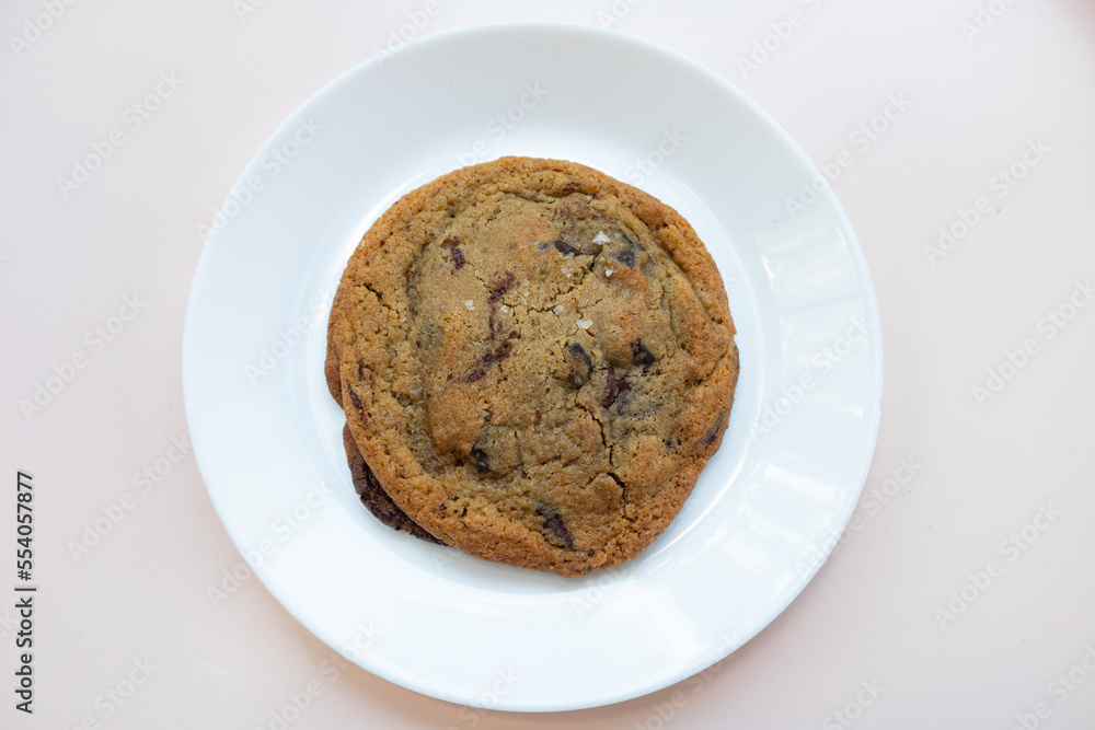 Delicious Chocolate Chip Cookie with Sea Salt on a White Plate Delicious Chocolate Chip Cookie with Sea Salt on a White Plate