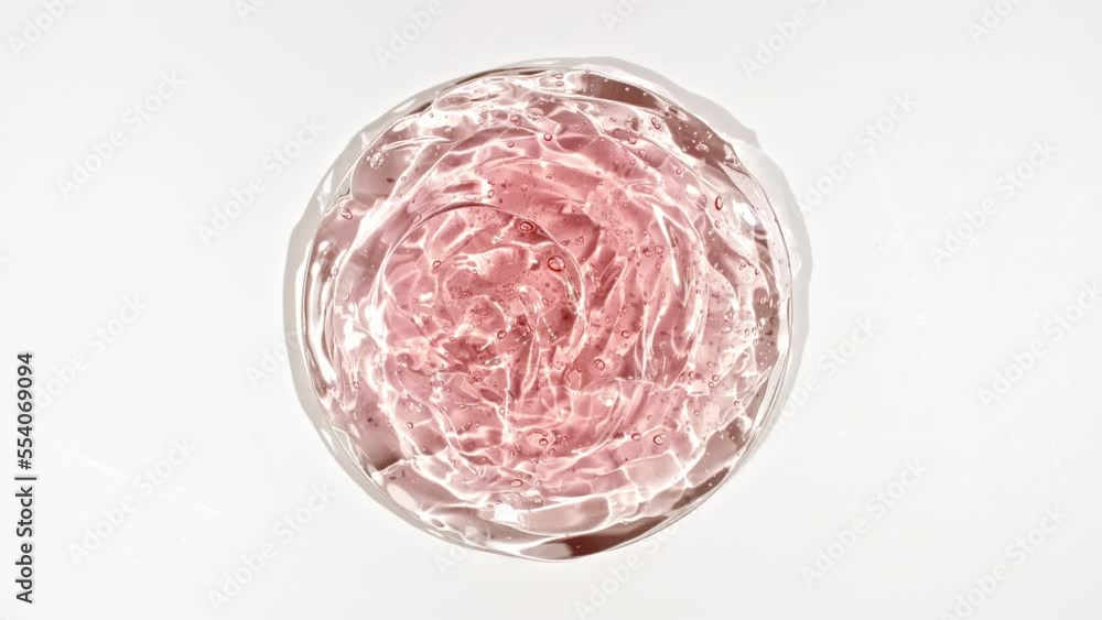 Rotation of Transparent Red Cosmetic Gel Fluid with Bubbles in a glass bowl of Petri. Macro Shot Serum, Cream, hyalurinic acid. Organic cosmetics, medicine. Concept Skin care. High quality 4k footage Rotation of Transparent Red Cosmetic Gel Fluid with Bubbles in a glass bowl of Petri. Macro Shot Serum, Cream, hyalurinic acid. Organic cosmetics, medicine. Concept Skin care. High quality 4k footage