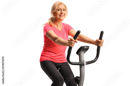 Mature woman in sportswear exercising on a stationary bike © Ljupco Smokovski