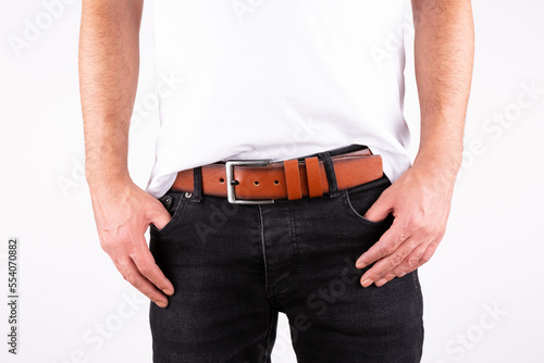 male model looks leather belt with hands in pocket